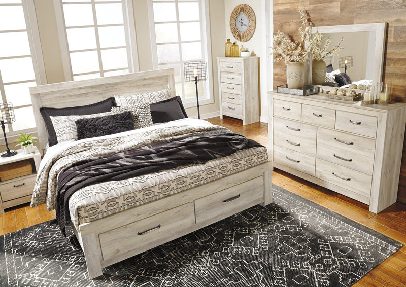 Ashley Furniture Bellaby Bed with two storage drawers, showcasing a wooden bed frame with built-in storage compartments in a modern bedroom setting.
