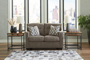 Ashley Furniture Mahoney living room set with sofa and loveseat, upholstered in neutral fabric, modern design for comfortable lounging.