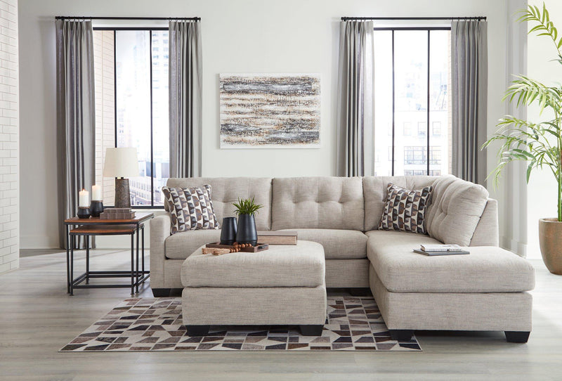 Ashley Mahoney Living Room Set featuring a plush sofa and matching chairs in a modern design with neutral fabric upholstery.
