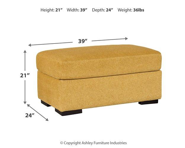 Ashley Furniture Keerwick living room set featuring a sofa and armchair with neutral upholstery and wooden legs.
