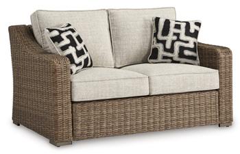 Ashley Furniture Beachcroft outdoor loveseat with cushion, featuring a cozy seating area and stylish design for outdoor relaxation.