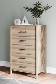 Ashley Furniture Battelle chest of drawers with six spacious wooden drawers and sleek silver handles on a modern bedroom setting.