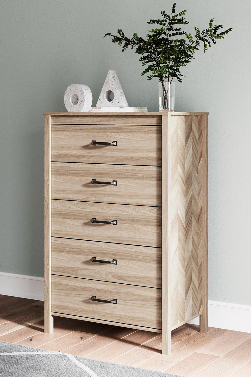 Ashley Furniture Battelle chest of drawers with six spacious wooden drawers and sleek silver handles on a modern bedroom setting.