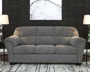 Ashley Furniture Allmaxx sofa with plush cushions and modern design, featuring neutral fabric upholstery and wide armrests.