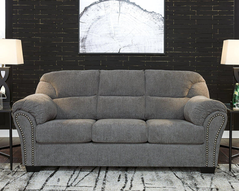 Ashley Furniture Allmaxx sofa with plush cushions and modern design, featuring neutral fabric upholstery and wide armrests.