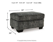 Ashley Furniture Lonoke living room set featuring a sofa and loveseat with neutral upholstery and wooden legs.