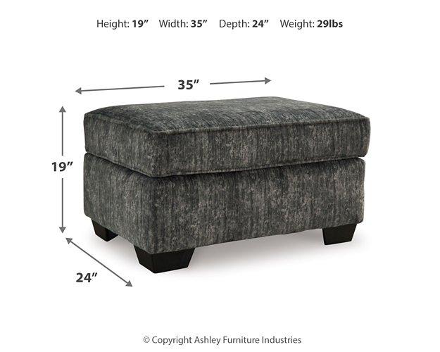 Ashley Furniture Lonoke living room set featuring a sofa and loveseat with neutral upholstery and wooden legs.