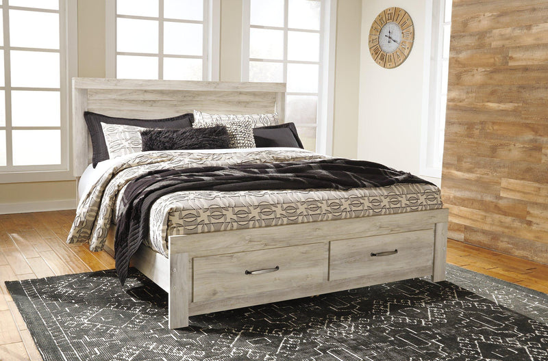 Ashley Furniture Bellaby bed with built-in storage drawers and a stylish wooden frame, ideal for modern bedroom decor.