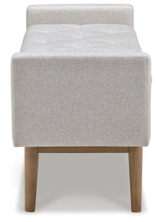 Ashley Furniture Briarson Storage Bench with cushioned top and wooden legs, ideal for entryways or living rooms.