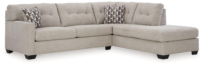 Ashley Mahoney living room set with sofa and armchair, featuring neutral upholstery and contemporary design.