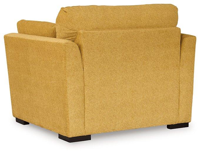 Ashley Furniture Keerwick living room set with sofa, loveseat, and armchair in a cozy, modern living room arrangement.