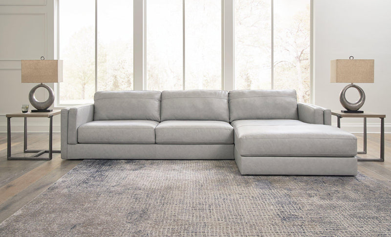 Ashley Furniture Amiata sectional with chaise, featuring plush fabric upholstery and modern design in a spacious living room setting.