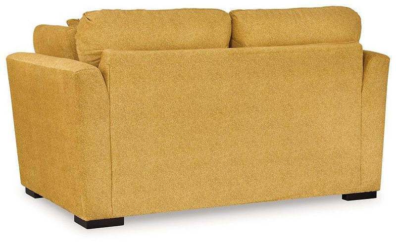 Ashley Furniture Keerwick living room set with sofa and matching armchair, featuring neutral upholstery and modern design.
