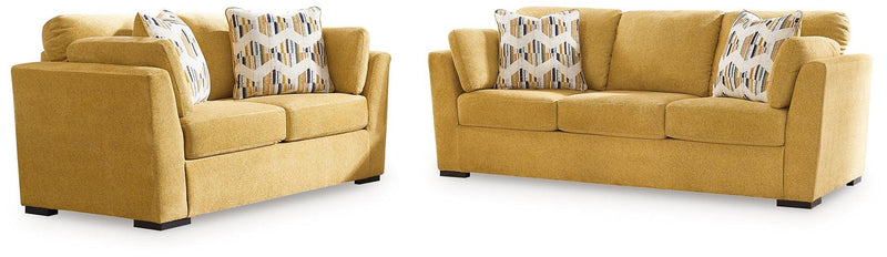 Ashley Furniture Keerwick living room set with sofa and armchair in a modern living space, featuring neutral upholstery and wooden accents.
