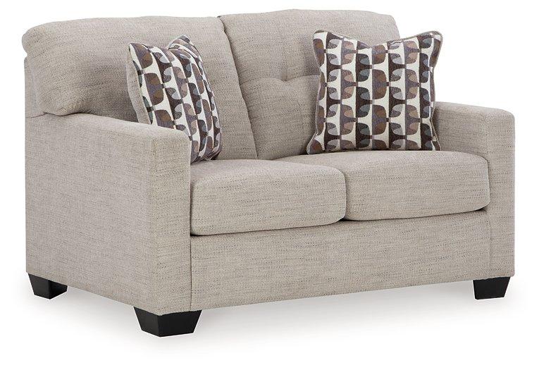 Ashley Furniture Mahoney living room set featuring a sofa, loveseat, and armchair in a modern design with neutral upholstery.