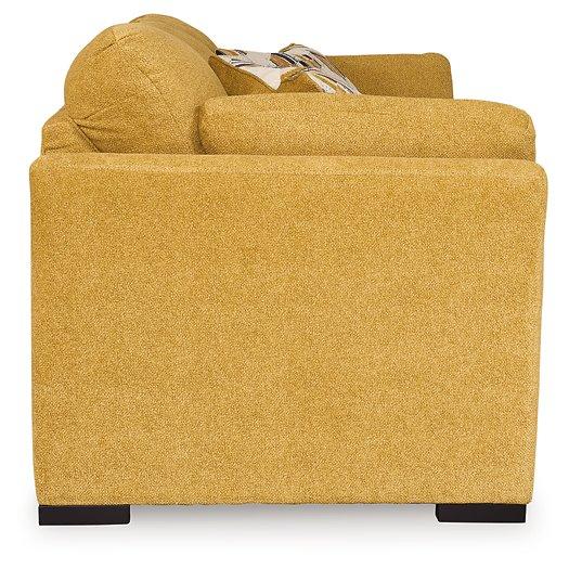 Ashley Furniture Keerwick living room set with sofa and loveseat in a modern design, shown in a cozy home setting.