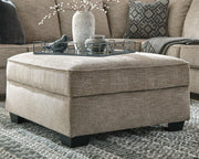 Ashley Bovarian living room set with plush sofa and matching armchair, featuring neutral upholstery and wooden legs.