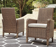 Set of two Ashley Furniture Beachcroft outdoor arm chairs with cushions, ideal for patio or garden seating.