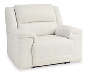 Ashley Furniture Keensburg oversized power recliner with plush upholstery and padded armrests, shown in a cozy living room setting.