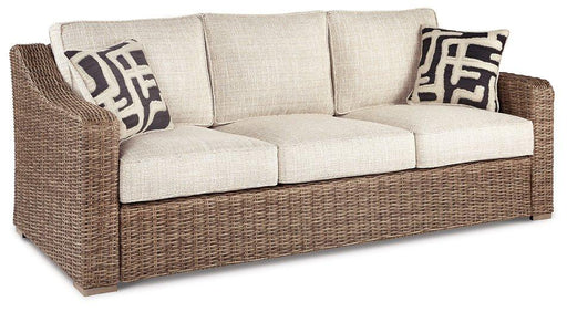 Ashley Furniture Beachcroft outdoor sofa with cushions, featuring a stylish outdoor seating area with plush cushions and weather-resistant frame.