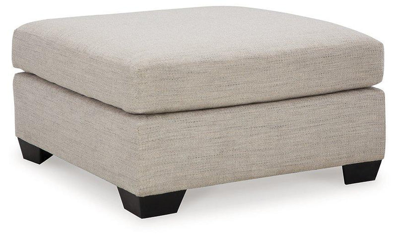 Ashley Furniture Mahoney living room set featuring a sofa, loveseat, and armchair with neutral upholstery and modern design.