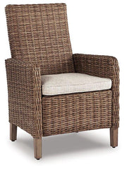 Set of two Ashley Furniture Beachcroft outdoor arm chairs with cushions, ideal for patio or garden seating.