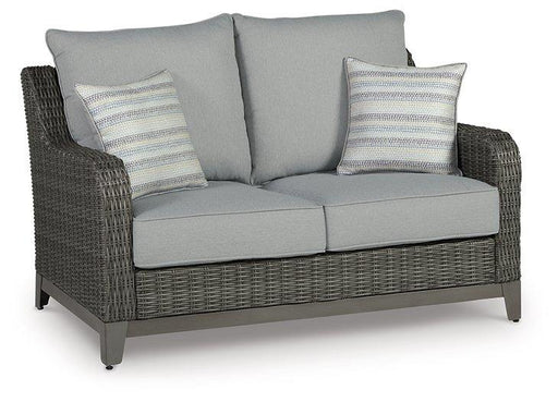 Outdoor loveseat from Ashley Furniture with a cushion, featuring a sturdy frame and comfortable seating for outdoor relaxation.