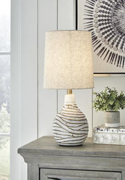 Aleela table lamp by Ashley Furniture with a sleek base and fabric shade, ideal for modern living room or bedroom decor.