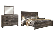 Ashley Furniture Wynnlow bedroom set with a bed, nightstands, and dresser in a modern bedroom design.