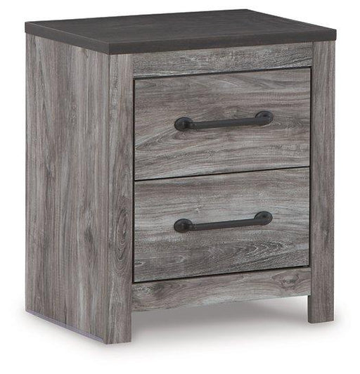 Ashley Furniture Bronyan nightstand with a sleek wood finish and modern design, featuring a single drawer and open storage shelf.