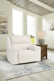 Ashley Furniture Keensburg oversized power recliner with plush fabric and padded armrests, shown in a cozy living room setting.