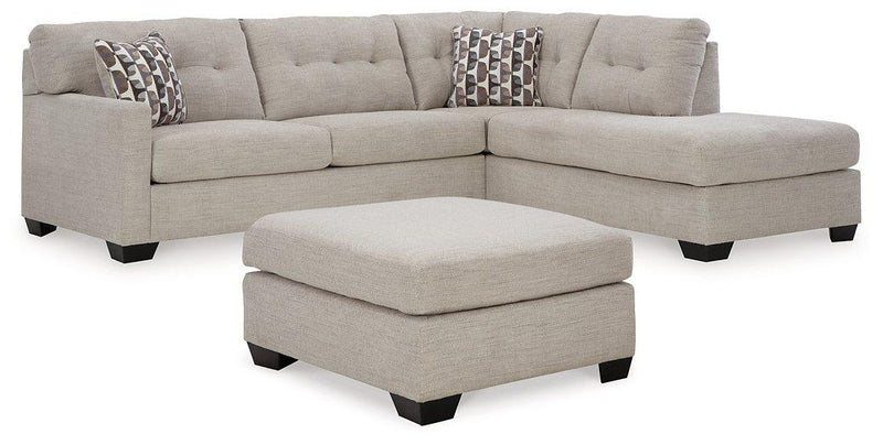 Ashley Furniture Mahoney living room set with a sofa and armchair, featuring neutral upholstery and modern design.
