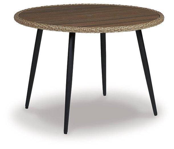 Amaris outdoor dining set by Ashley Furniture featuring a round table and six chairs with cushioned seats for outdoor use.