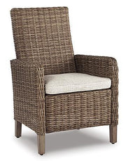Set of two Ashley Furniture Beachcroft outdoor arm chairs with cushions, ideal for patio or garden seating.