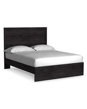Ashley Furniture Belachime bedroom set featuring a bed with a padded headboard, matching nightstands, and a contemporary design.