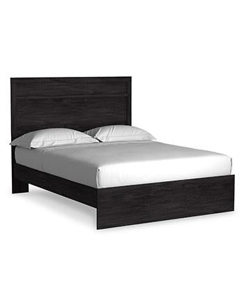 Ashley Furniture Belachime bedroom set featuring a bed with a padded headboard, matching nightstands, and a contemporary design.