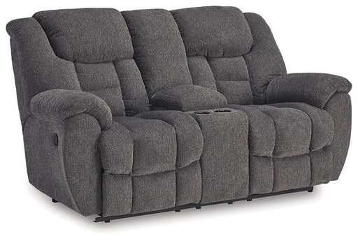 Ashley Furniture reclining loveseat with built-in console, plush fabric, and cushioned armrests for comfortable seating.