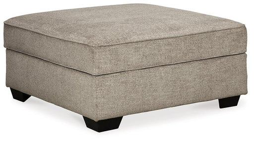 Ashley Bovarian Ottoman showing a plush, upholstered ottoman with a contemporary design and neutral fabric finish.