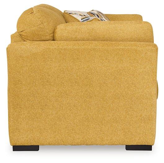 Ashley Furniture Keerwick living room set with sectional sofa and matching ottoman in a modern living space.