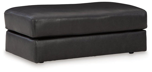 Ashley Furniture Amiata Ottoman with plush fabric, sturdy wooden legs, and a versatile design for living room or lounge spaces.