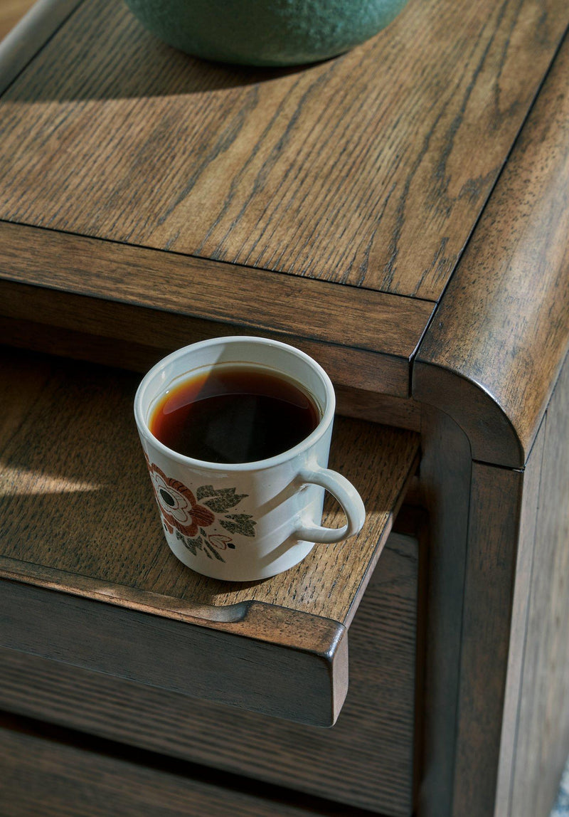 Ashley Furniture Jensworth accent table with a sleek wood finish and modern design, perfect for living room or bedroom décor.