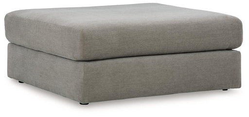 Ashley Furniture Avaliyah oversized accent ottoman with plush fabric and modern design, shown in a cozy living room setting.