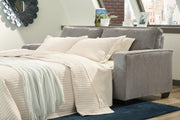 Ashley Furniture Altari sofa sleeper with plush fabric, shown in a living room setting with a modern design and comfortable seating.