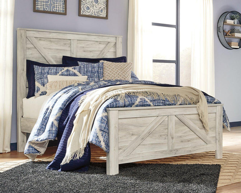 Ashley Furniture Bellaby Crossbuck Bed with sturdy wooden frame and crossbuck headboard in a natural finish.