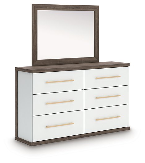Ashley Furniture Kendanport dresser with matching mirror, featuring a modern wood finish and sleek hardware, shown from an angled side view.