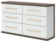 Ashley Furniture Kendanport Dresser with sleek wood finish, featuring multiple drawers and modern design, shown from an angled side view.