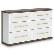 Ashley Furniture Kendanport Dresser with multiple drawers, shown from an angled view in a modern bedroom setting.