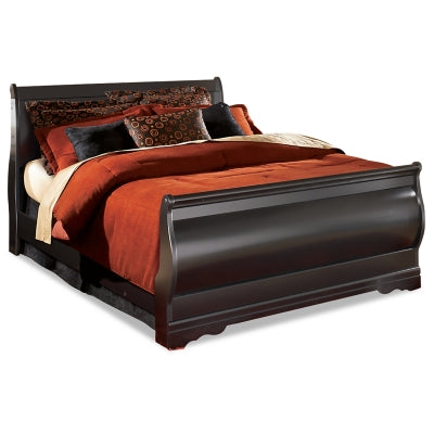 Ashley Furniture Huey Vineyard Bed with a wooden frame and upholstered headboard, shown in a cozy bedroom setting.