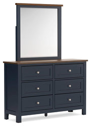 Ashley Furniture Landocken bedroom set with wooden bed, matching nightstands, and dresser in a cozy bedroom scene.