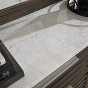 Close-up of the top detail of the Ashley Furniture Arkenton Dresser, showcasing its smooth surface and elegant design.